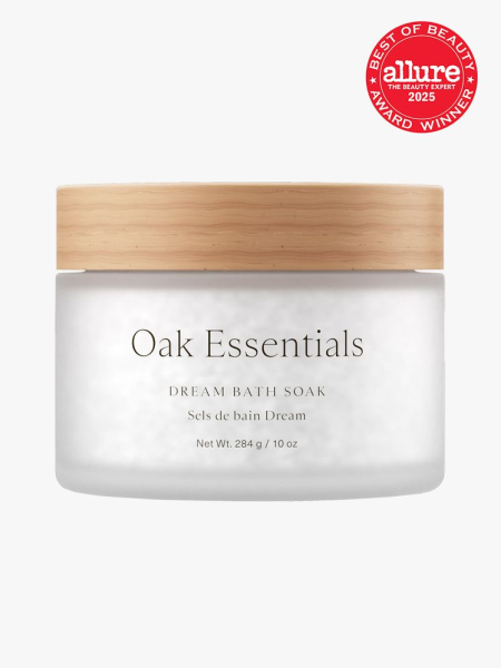Oak Essentials Dream Bath Soak in frosted clear jar with wooden lid on light gray background with red Allure Best of Beauty seal in the top right corner