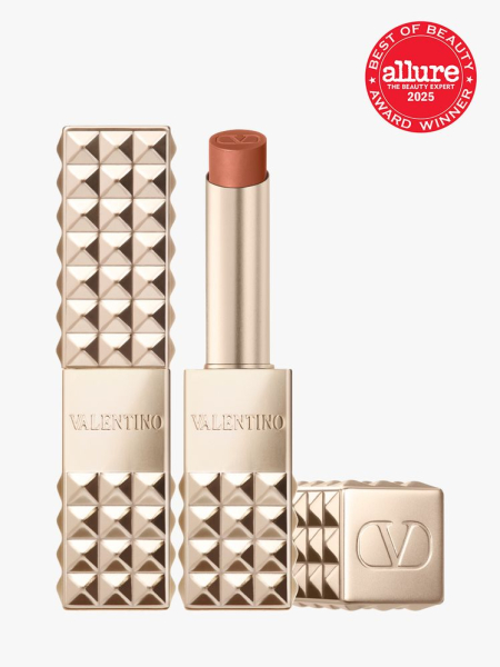 Valentino Beauty Spike Valentino Buttery Matte Lip Color two gold spiky tubes of lipstick with cap to the side on light gray background with red Allure Best of Beauty seal in the top right corner