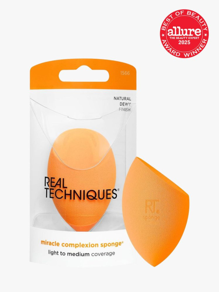 Real Techniques Miracle Complexion Sponge in branded clear packaging next to additional sponge on light gray background with red Allure Best of Beauty seal in the top right corner