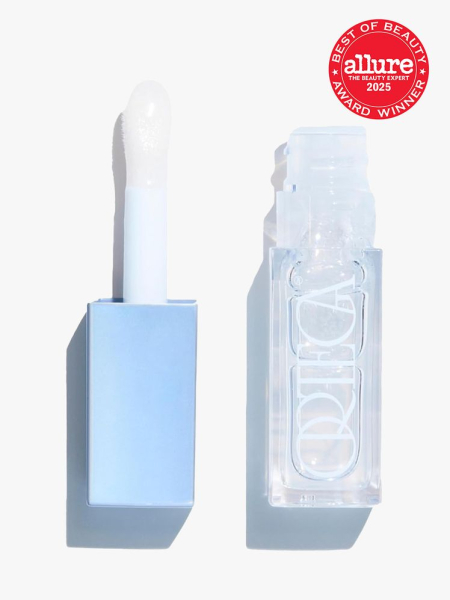 Ortega Liquid Icon Hyper Gloss light blue tube of lip gloss with cap and wand to the side on light gray background with red Allure Best of Beauty seal in the top right corner