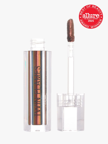 Danessa Myricks Beauty Twin Flames in clear holographic branded tube next to clear doe foot applicator on light gray background with red Allure Best of Beauty seal in the top right corner